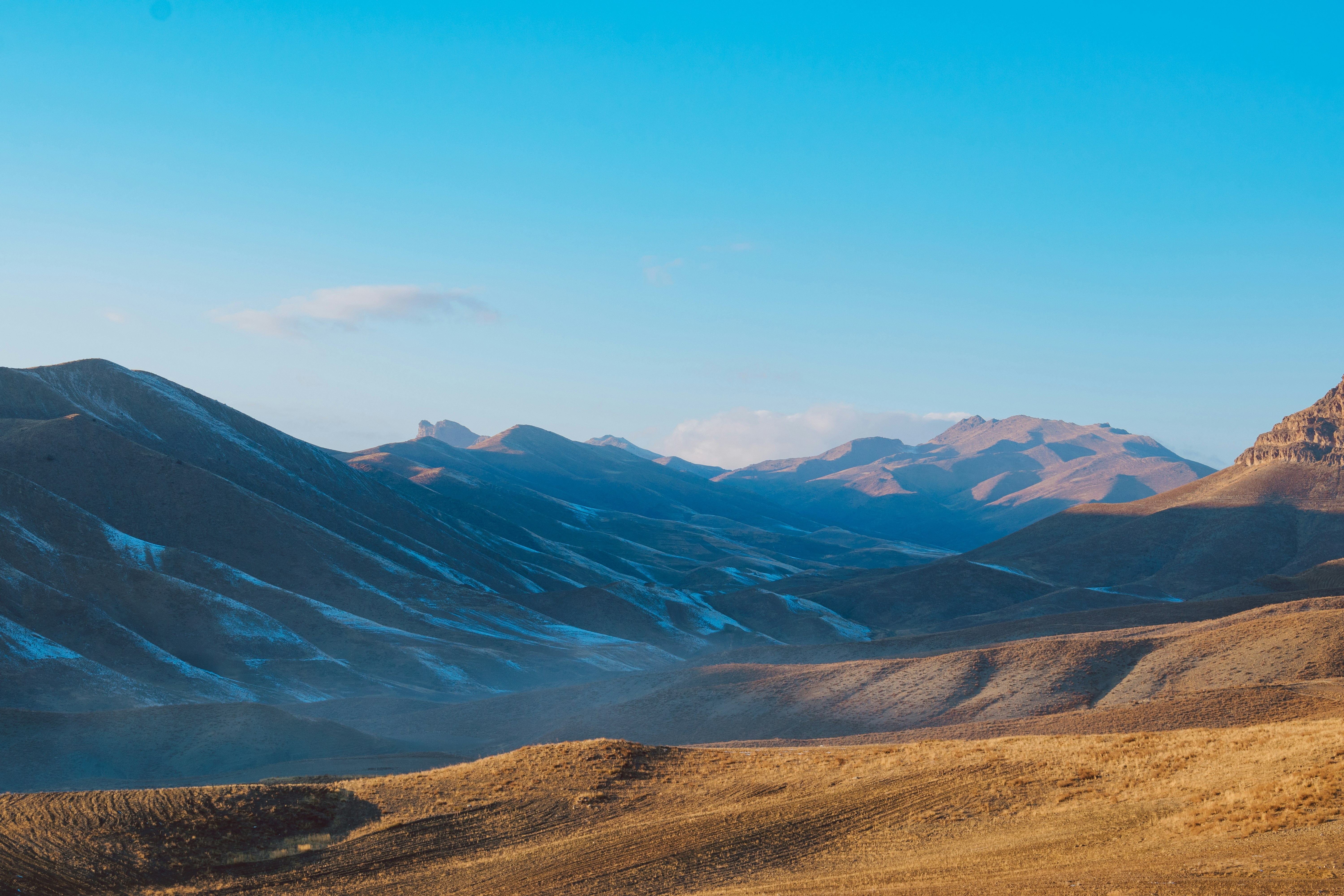 green and brown mountains under blue sky during daytime